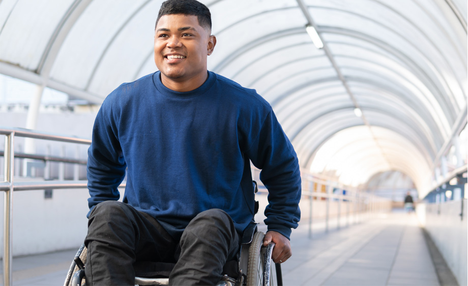 happy disabled black man climbing tunnel ramp looking forward.